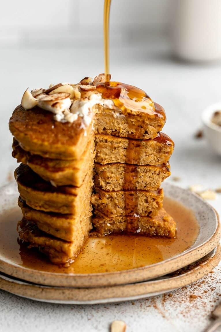 stack of butternut squash and apple pancakes with maple syrup