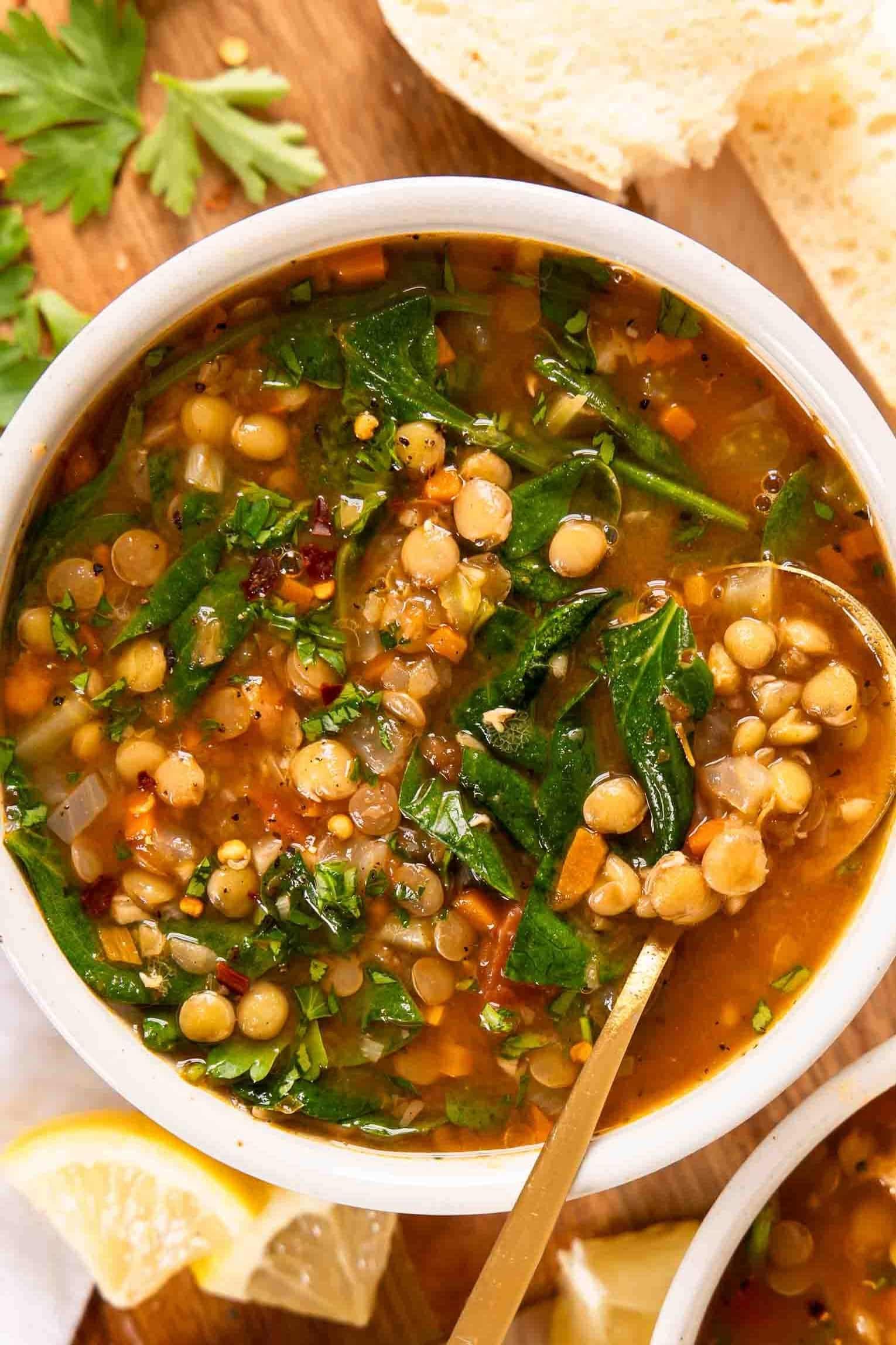 a family gathered around a table, enjoying bowls of lentil soup