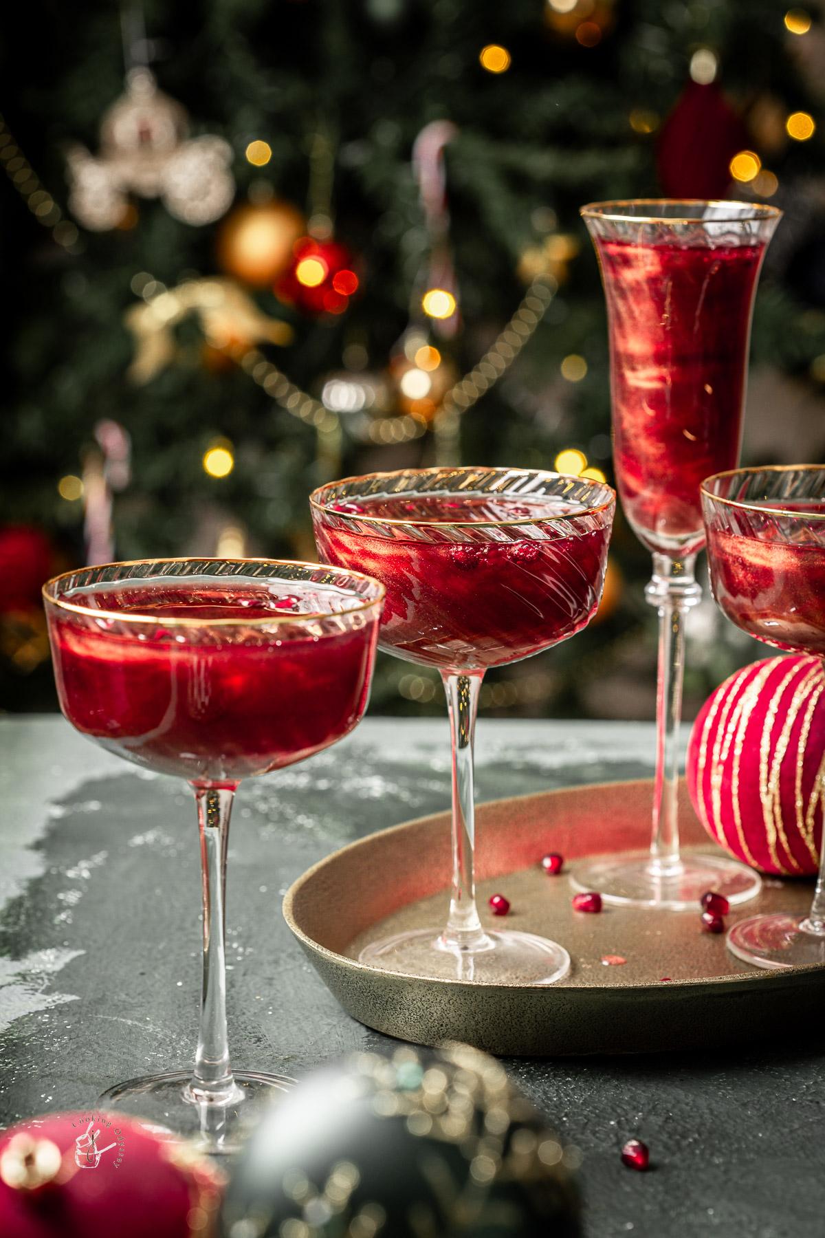 kids laughing while holding glasses of sparkling pomegranate mocktail, blurred festive background