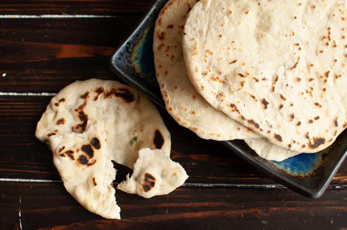 homemade cilantro lime flatbread on a rustic wooden board