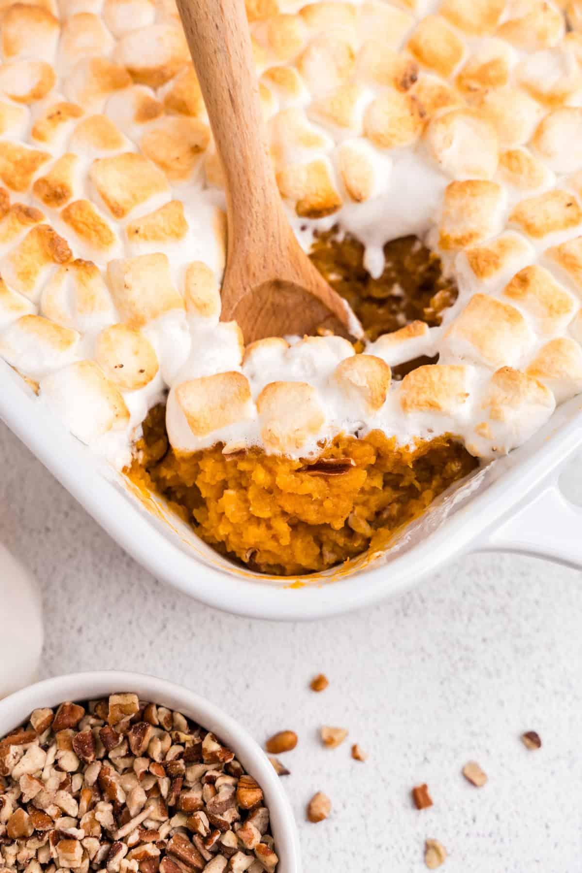 close-up shot of a spoon scooping creamy sweet potato casserole