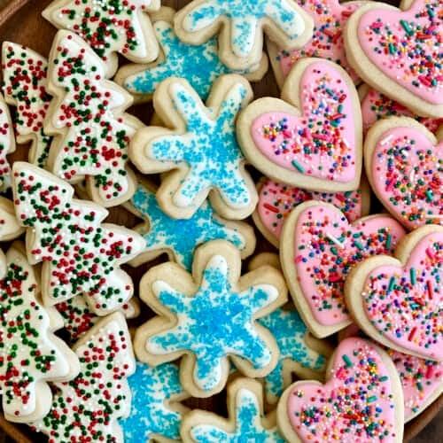freshly baked sugar cookies with a delicate icing drizzle, arranged artfully on a plate