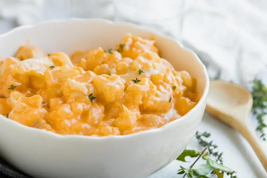 steaming bowl of cheesy cauliflower mac close up, focus on the creamy texture