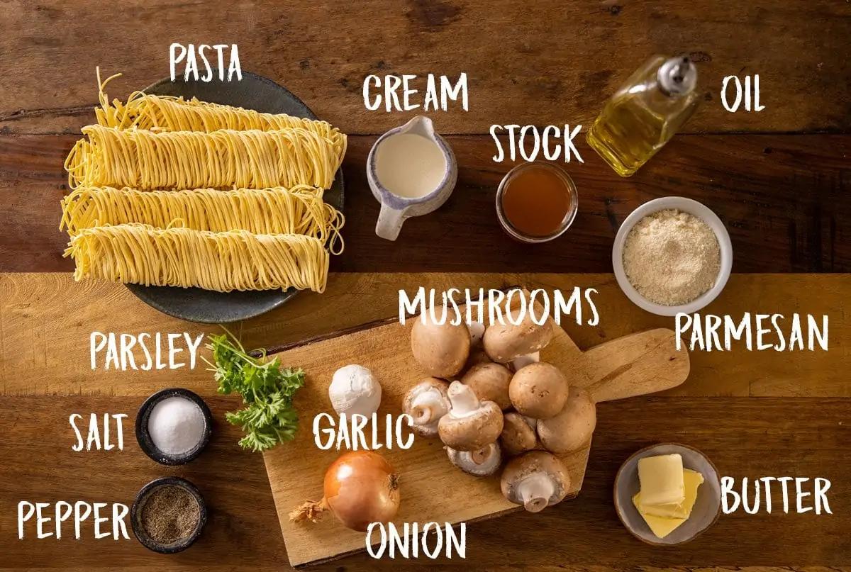 Ingredients for creamy mushroom pasta laid out on a kitchen counter