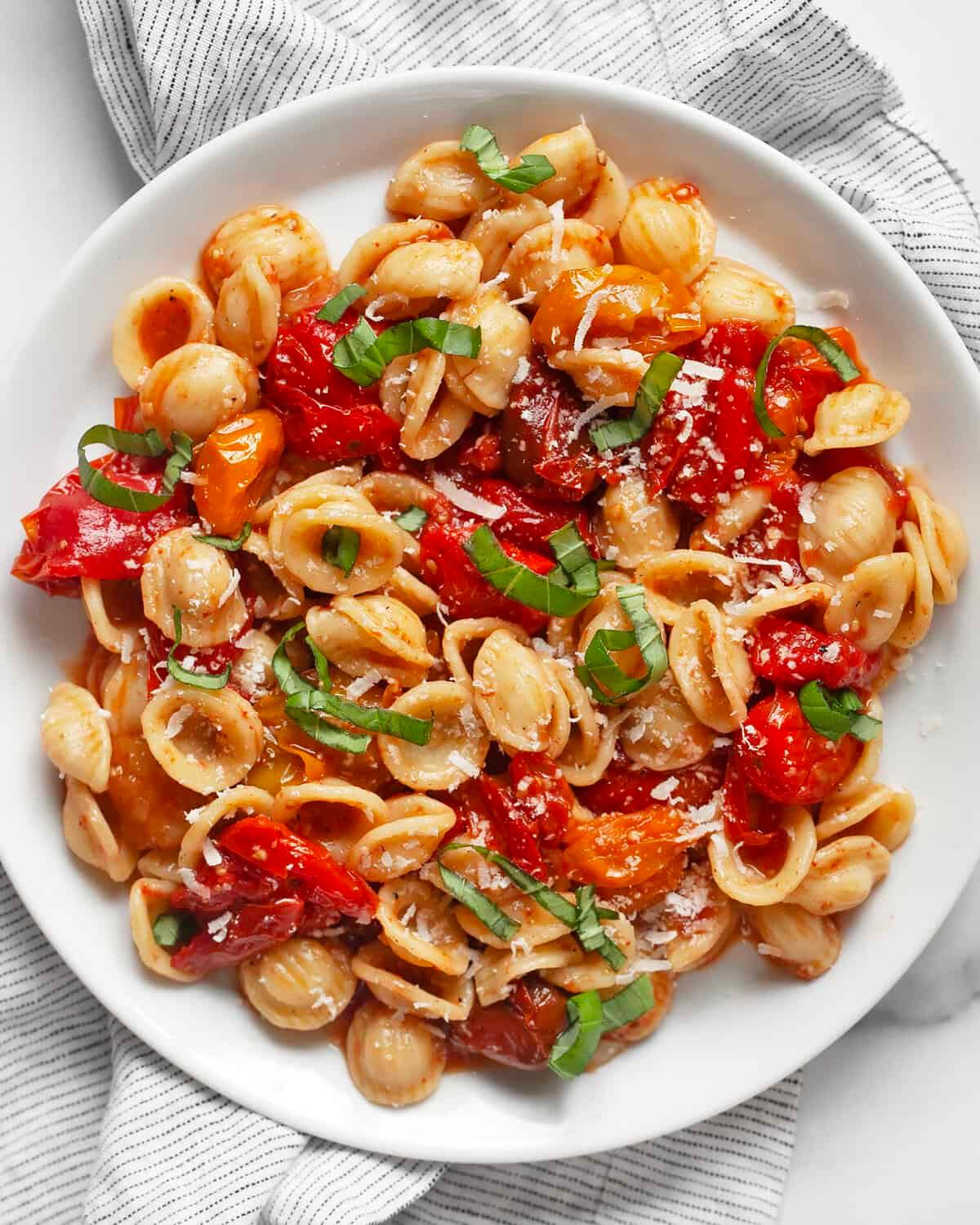 bowl of Roasted Tomato and Garlic Gluten-Free Pasta garnished with basil