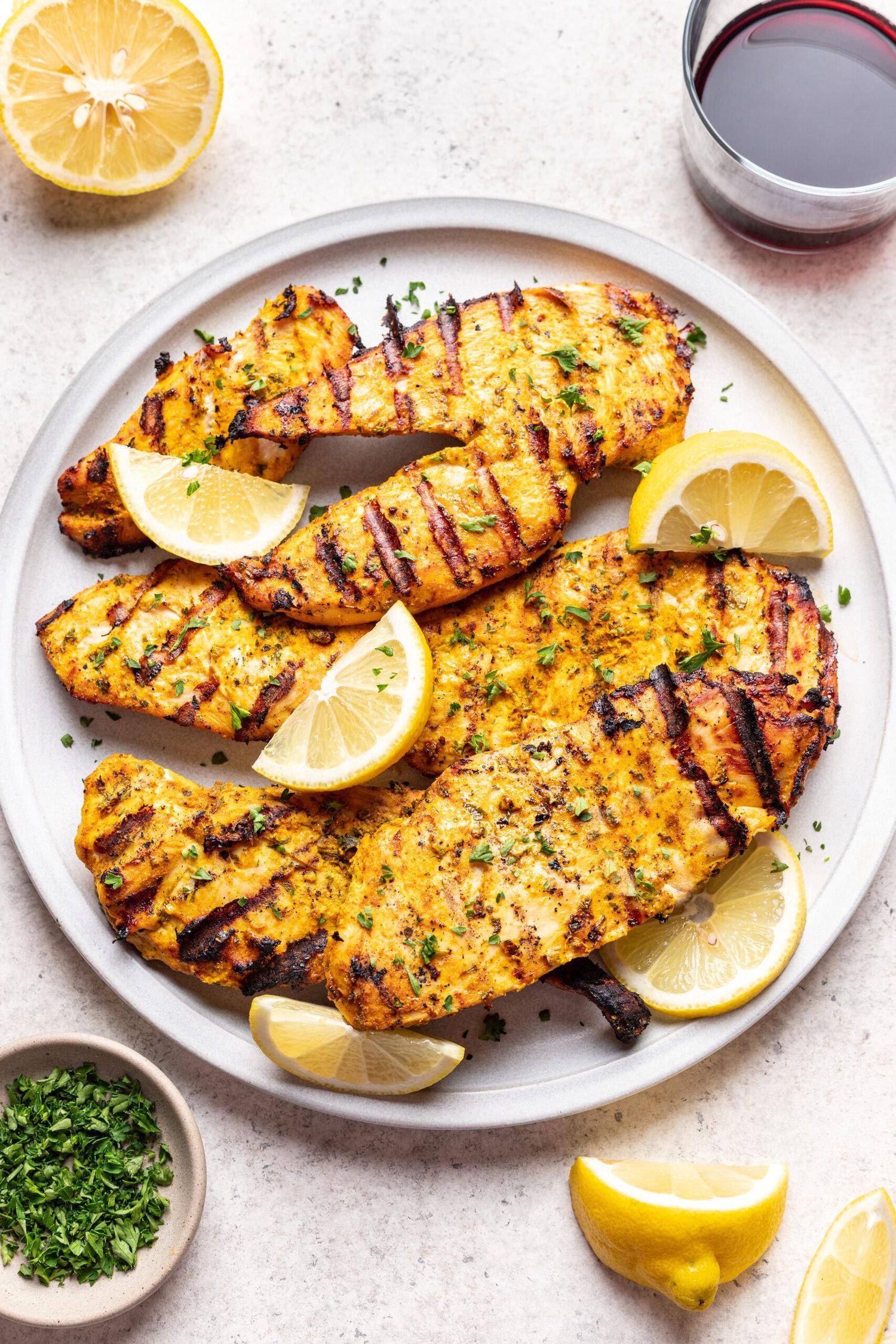 marinating chicken pieces in a vibrant yogurt spice blend