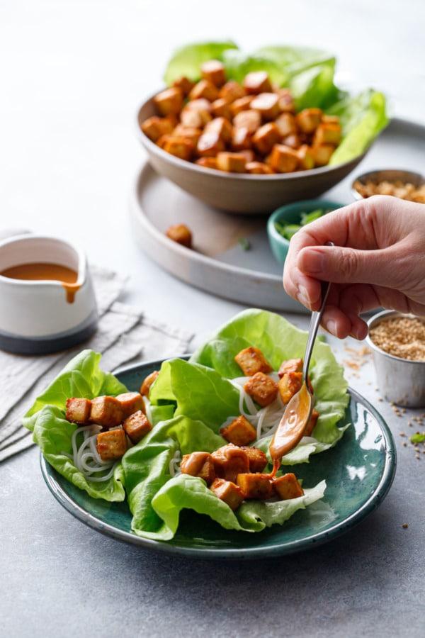 Various vegetables being prepped for spicy peanut tofu wraps