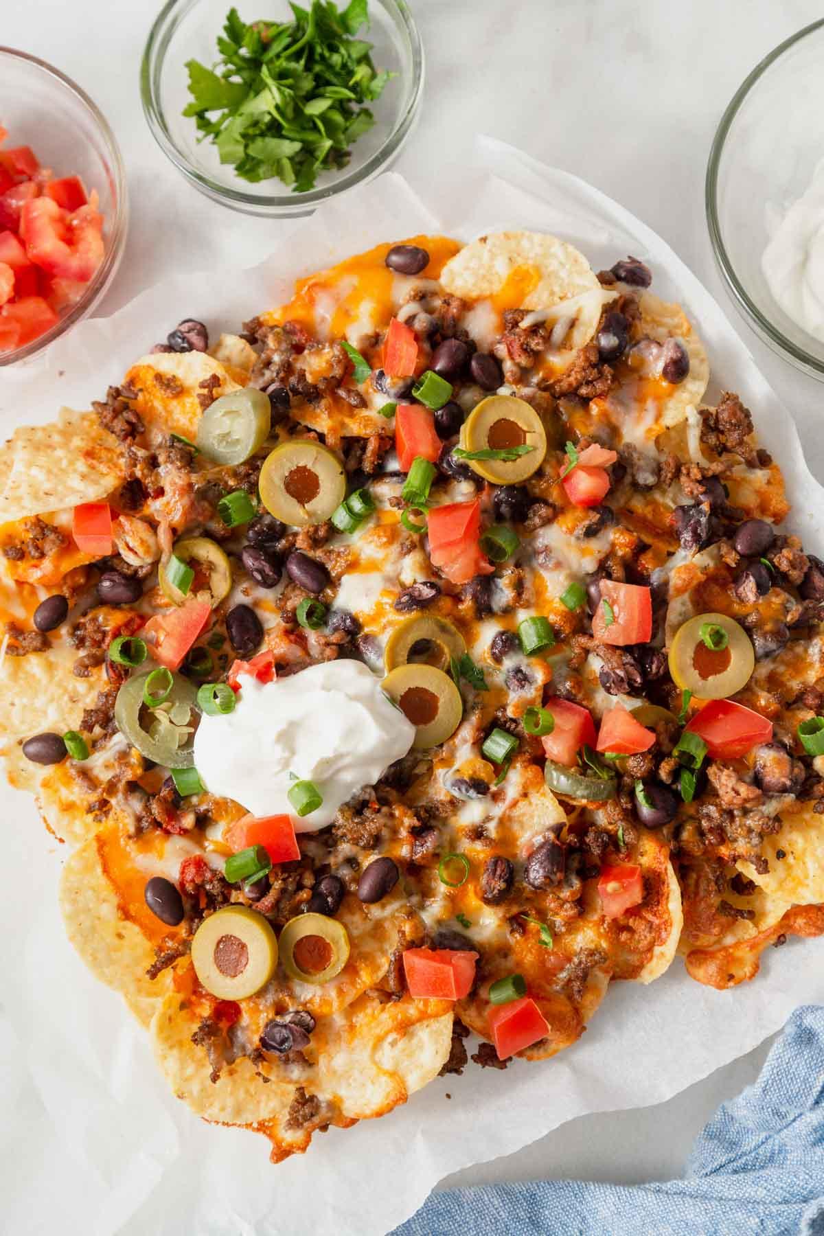 overhead shot of feijoada nachos piled high with toppings
