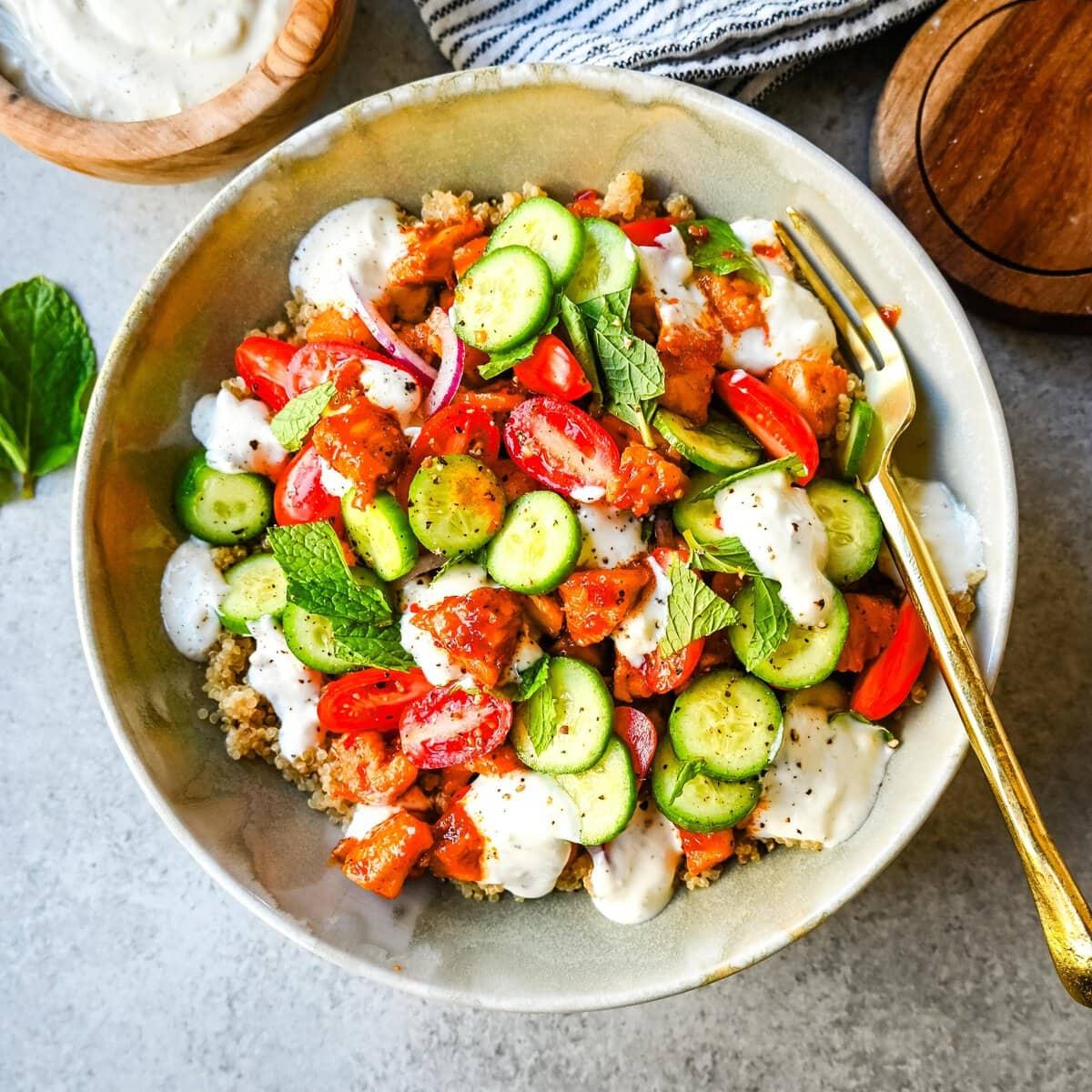 bowl of modern mediterranean tzatziki with a spoon scooping some out