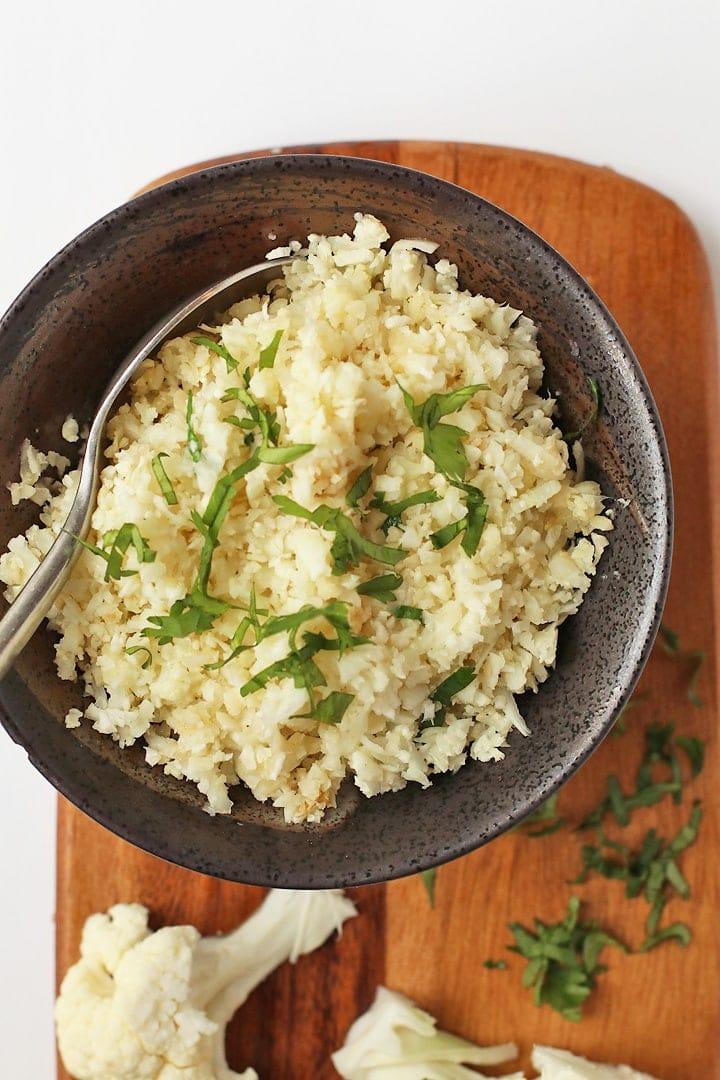 ingredients for cauliflower rice with hazelnuts and chocolate laid out on a wooden surface