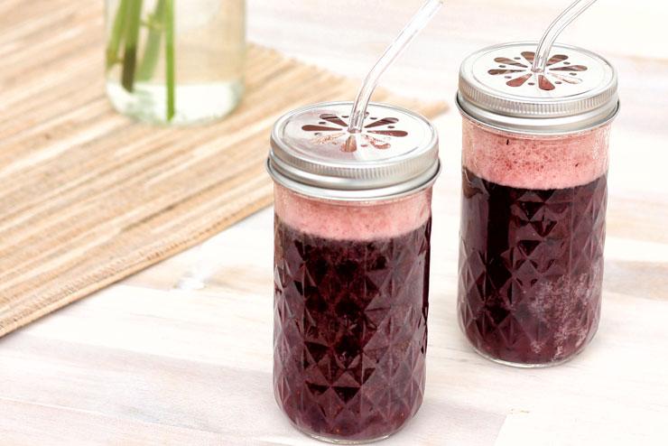 Glass of acai berry kombucha with ice and berries