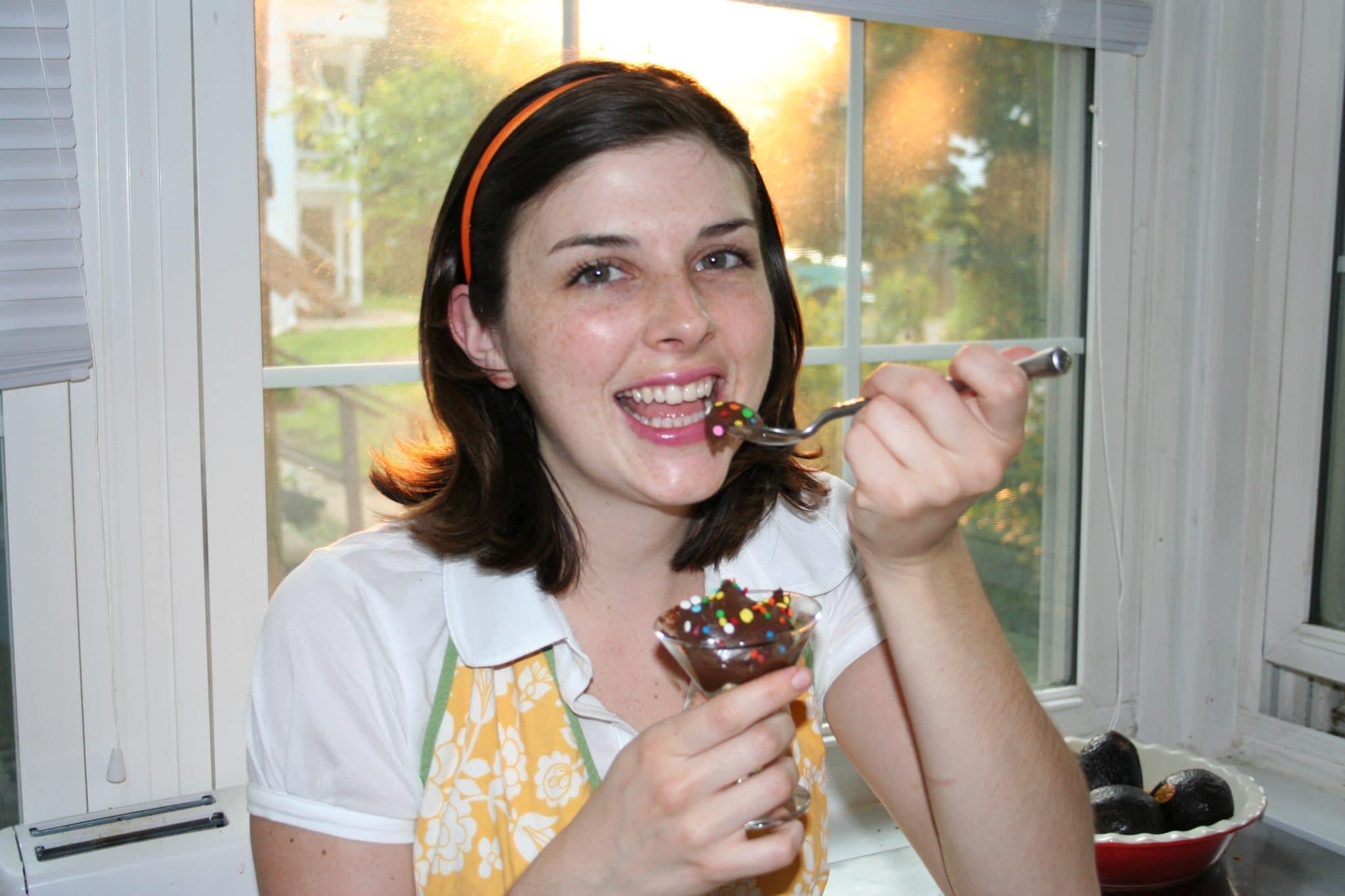 person tasting chocolate avocado mousse with a surprised expression
