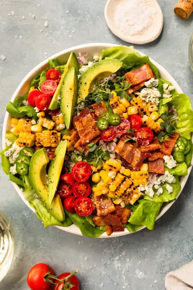 california veggie rice bowl with avocado, romaine lettuce, cherry tomatoes, red onion, and lemon vinaigrette