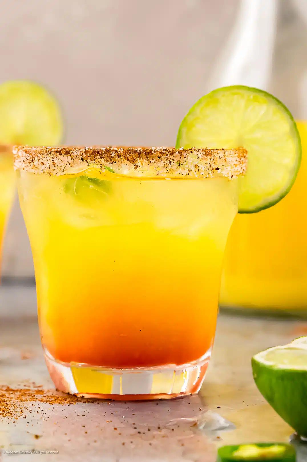 tropical tequila cocktail with pineapple and mango garnish