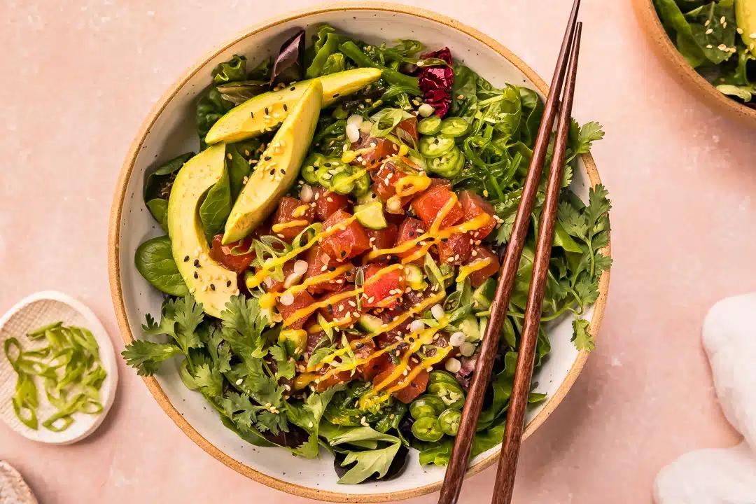 Overhead shot of four vibrant Spicy Tuna Poke Bowls with Mango Salsa, each bowl beautifully arranged with colorful ingredients.