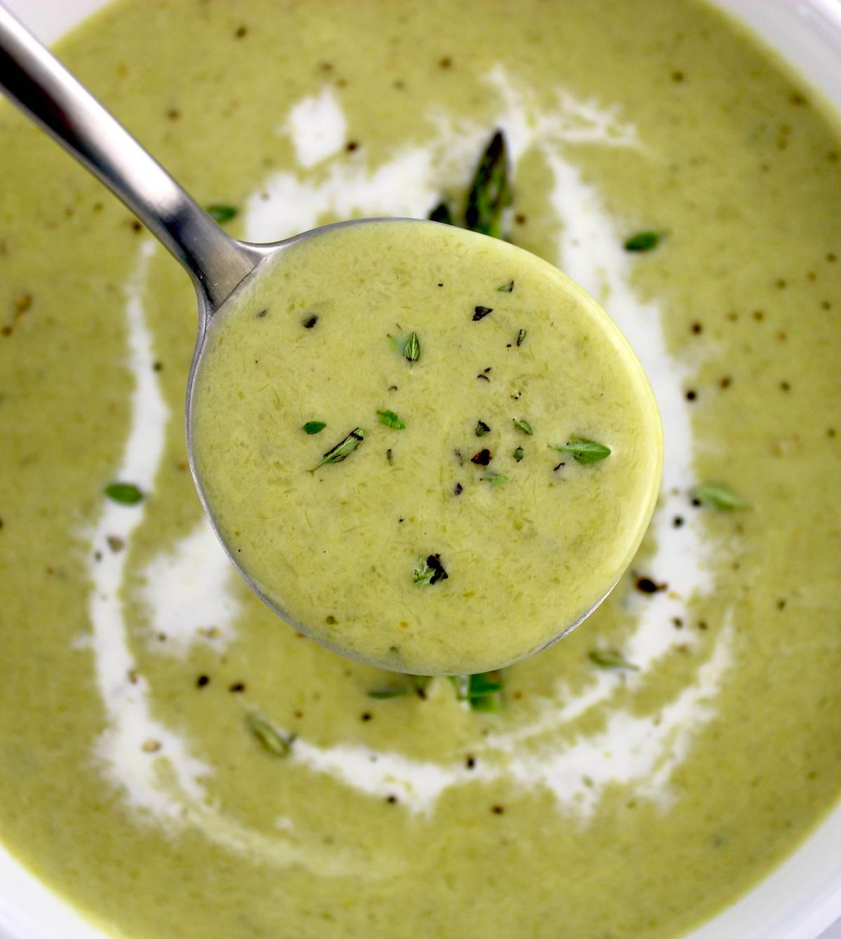 close-up shot of creamy asparagus soup being poured into a bowl