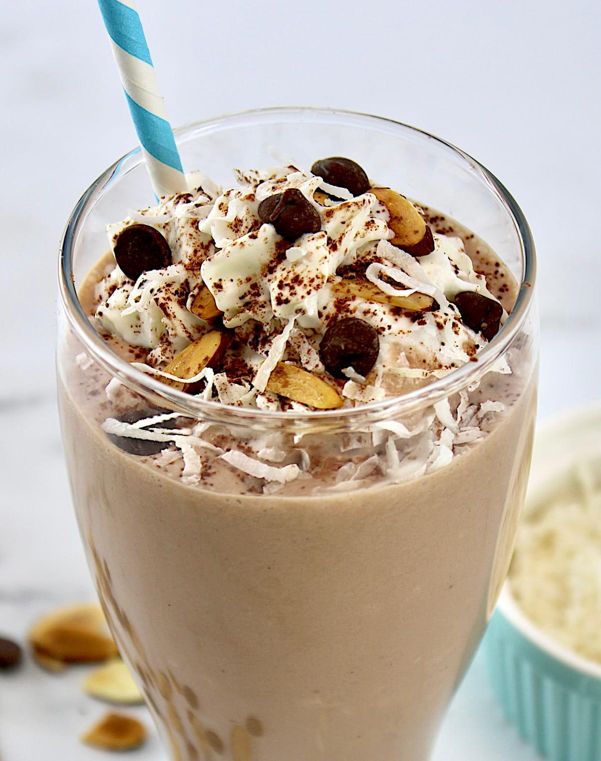 Close-up shot of a glass of Almond Joy Awakening Smoothie with visible ingredients