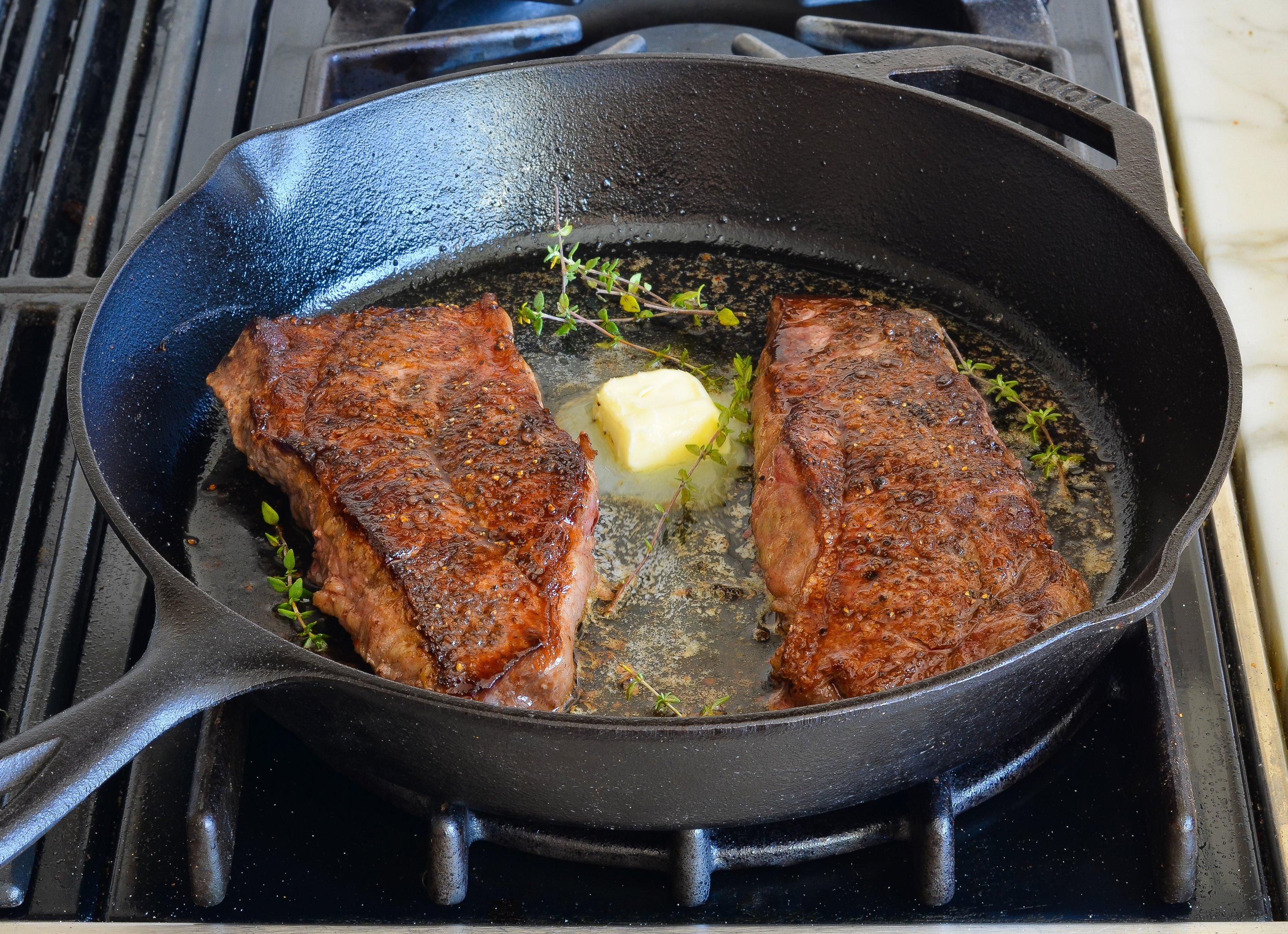 cooking steak in a pan