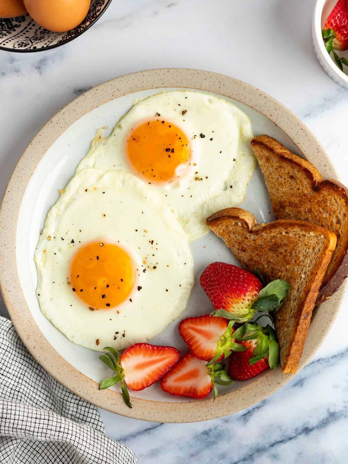 close-up shot of a perfectly cooked fried egg on top of a breakfast bowl