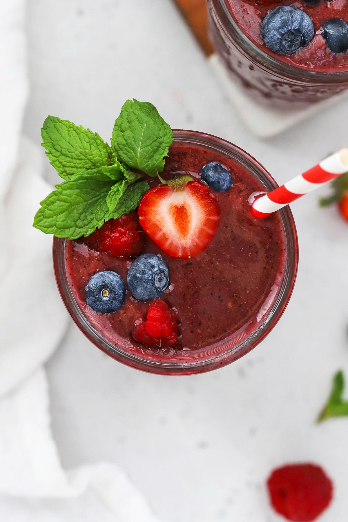 vibrant green smoothie with mixed berries and fresh mint