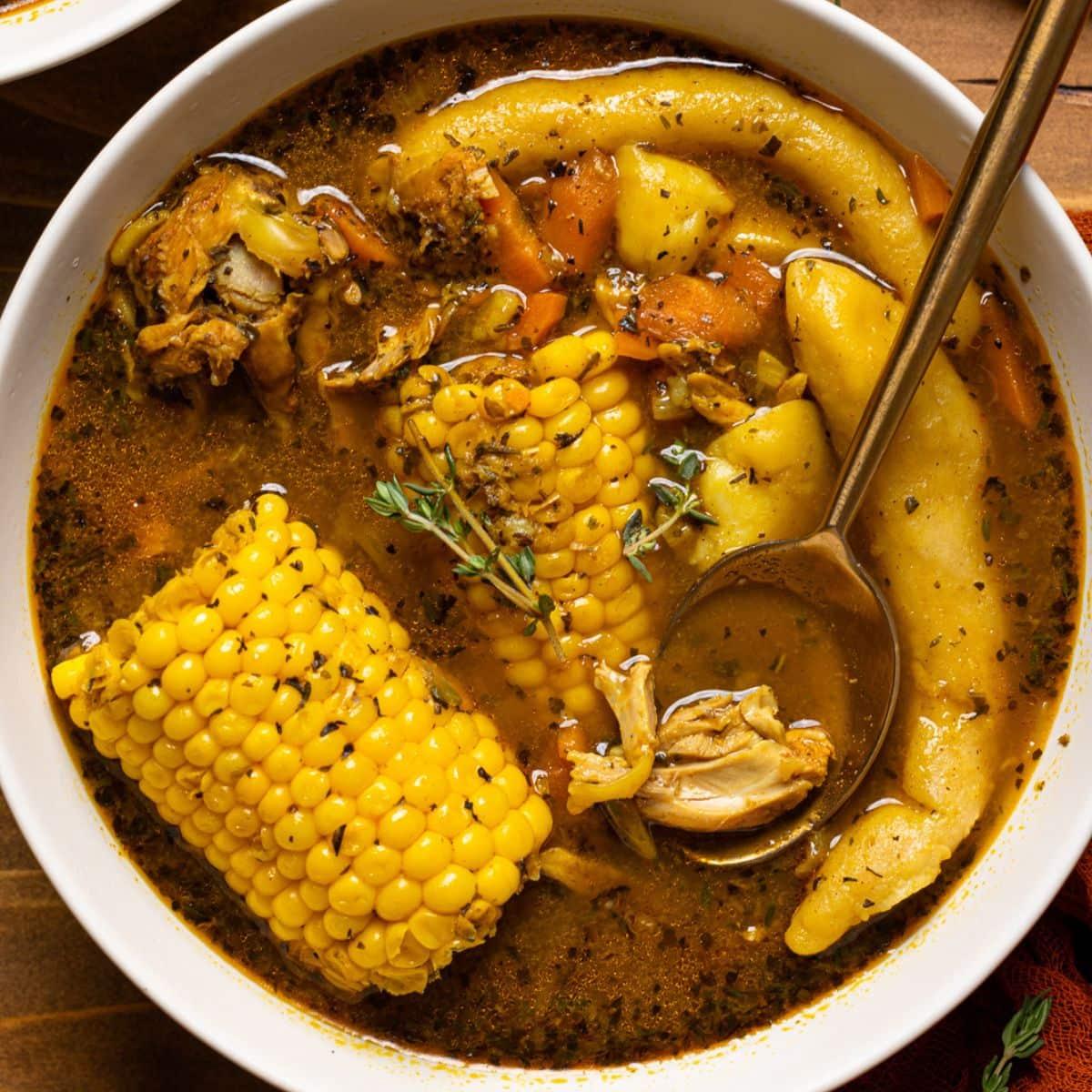 bowl of jerk chicken noodle soup with scotch bonnet peppers