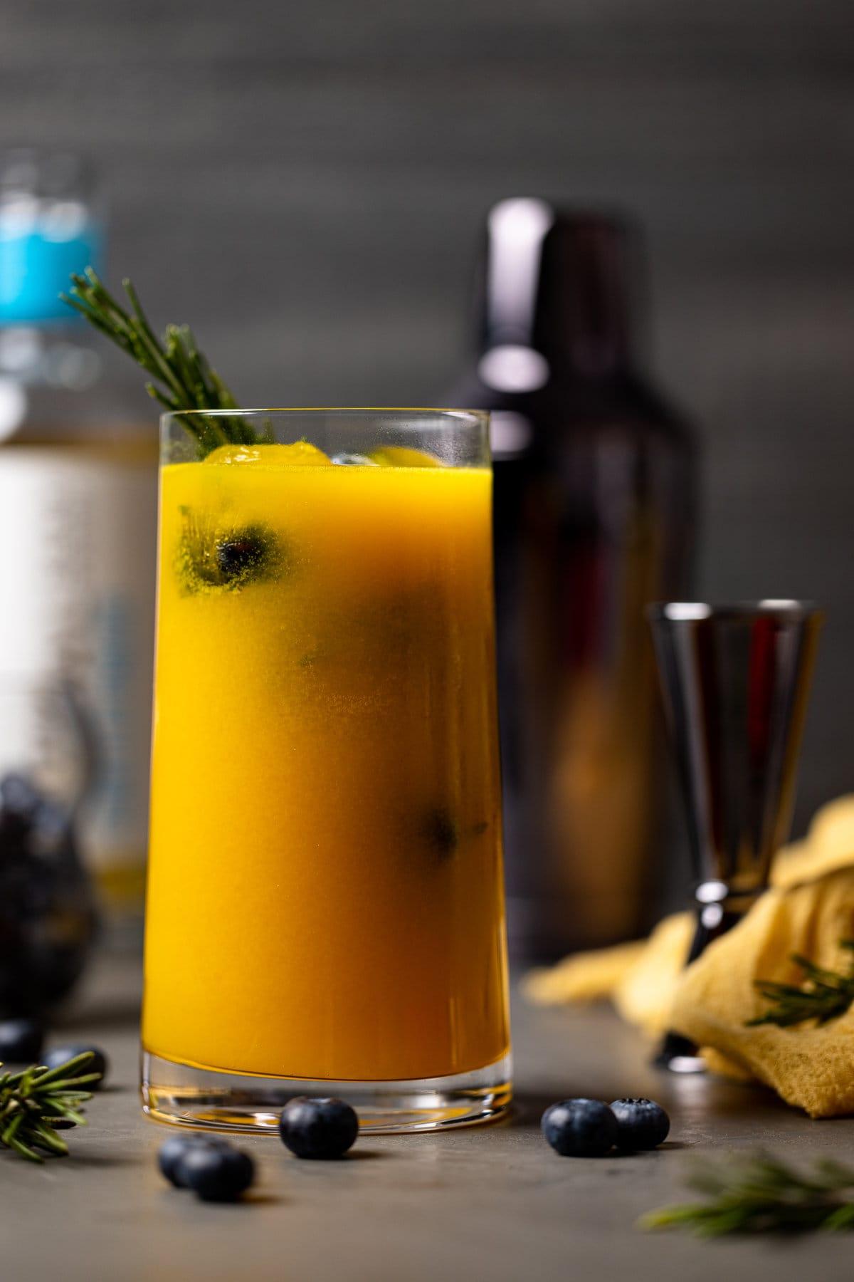 A person sipping the mango peach kombucha mocktail