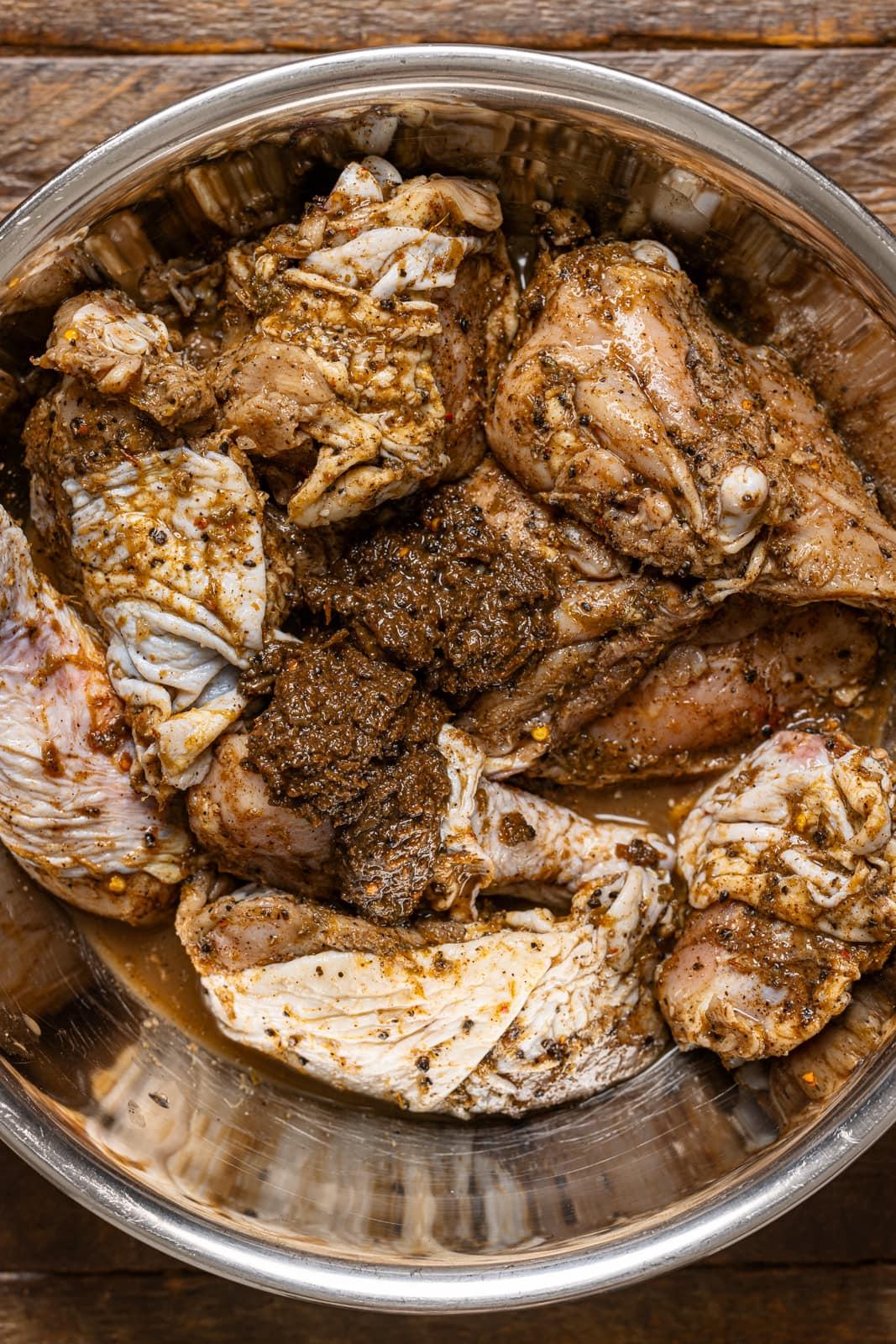 Close-up of jerk chicken marinating in a bowl