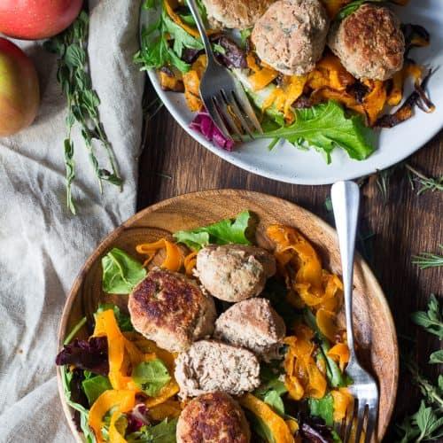 paleo roasted vegetable and turkey meatballs plated and garnished with fresh herbs