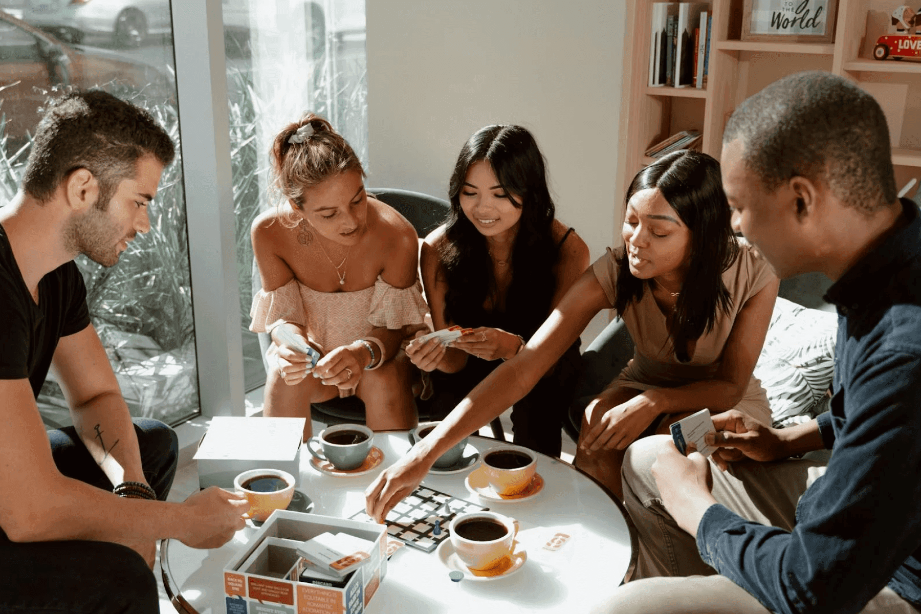 happy group of friends enjoying appetizers at a game night