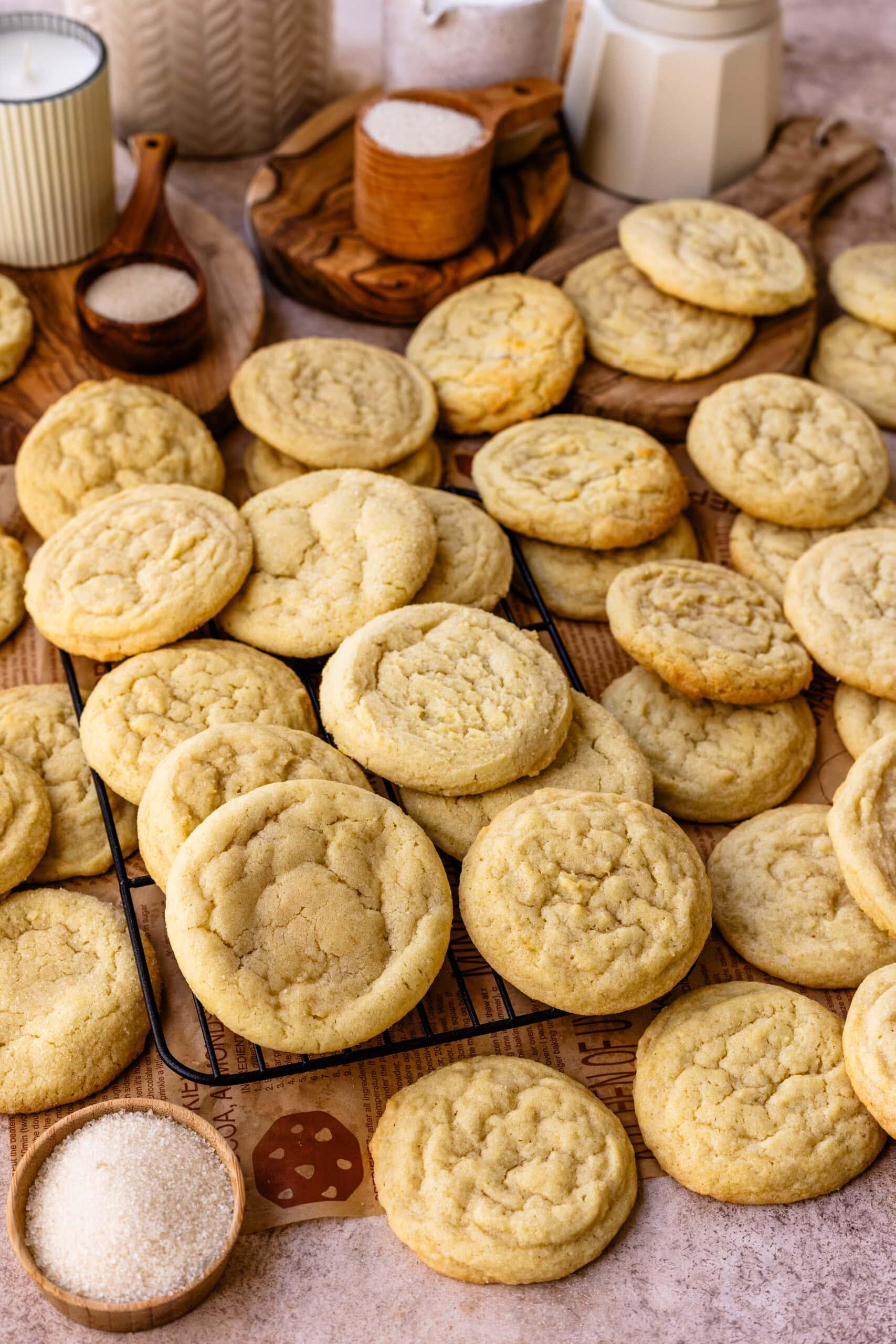plate of freshly baked sugar cookies with soft centers and crisp edges on a cooling rack, cozy kitchen setting