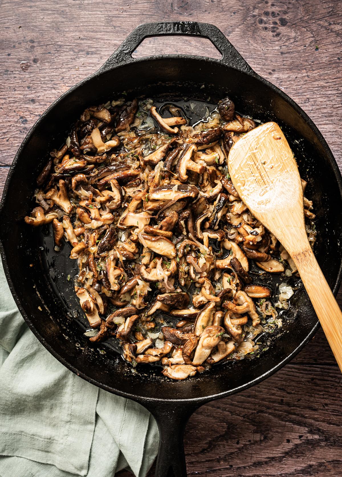 Overhead shot of wild mushroom medley rice being cooked in a skillet