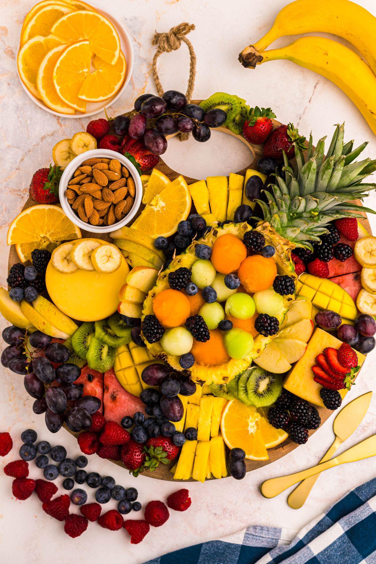 assorted banana bites and berry stacks on a wooden platter