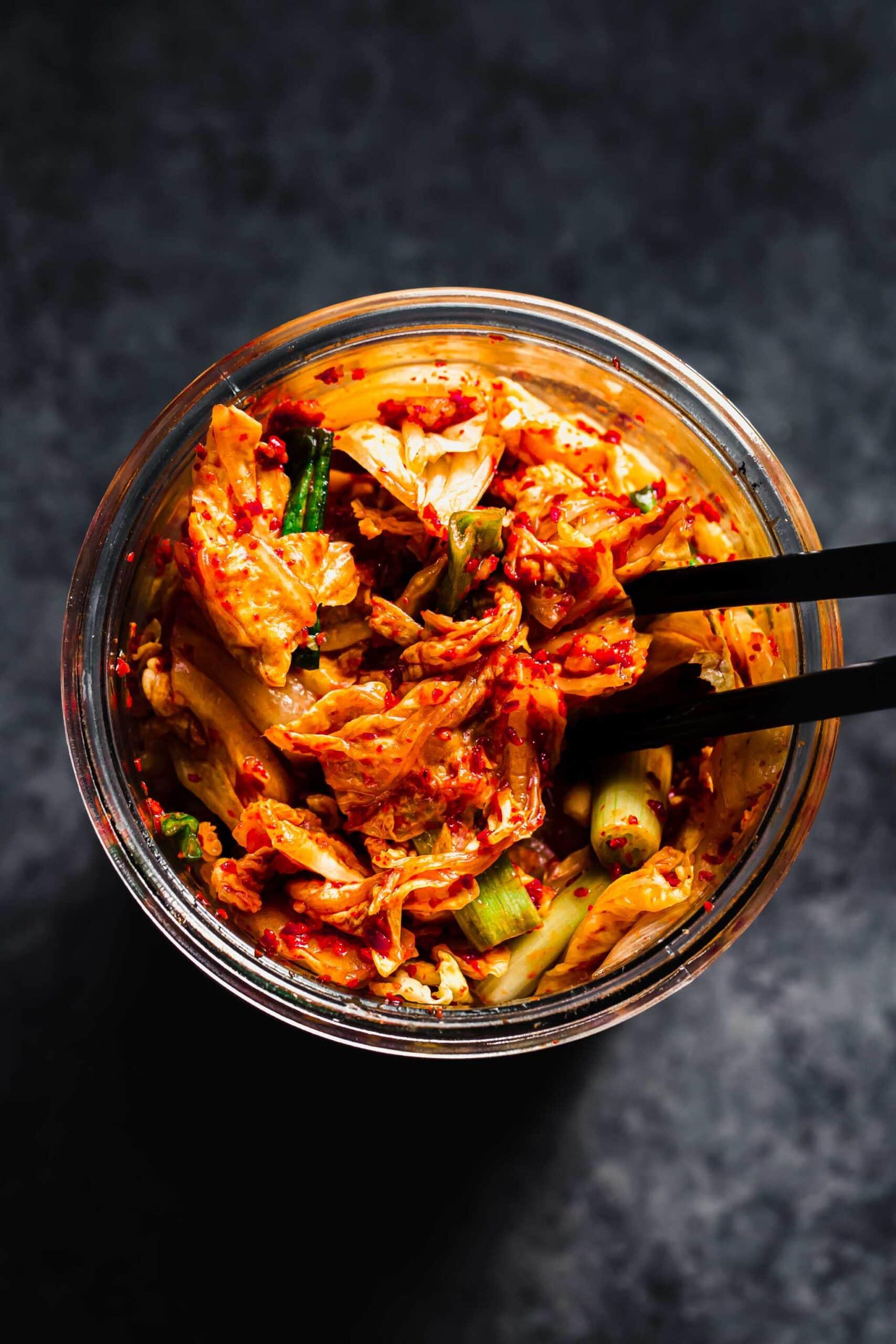top-down view of a bowl of kimchi chili with various toppings