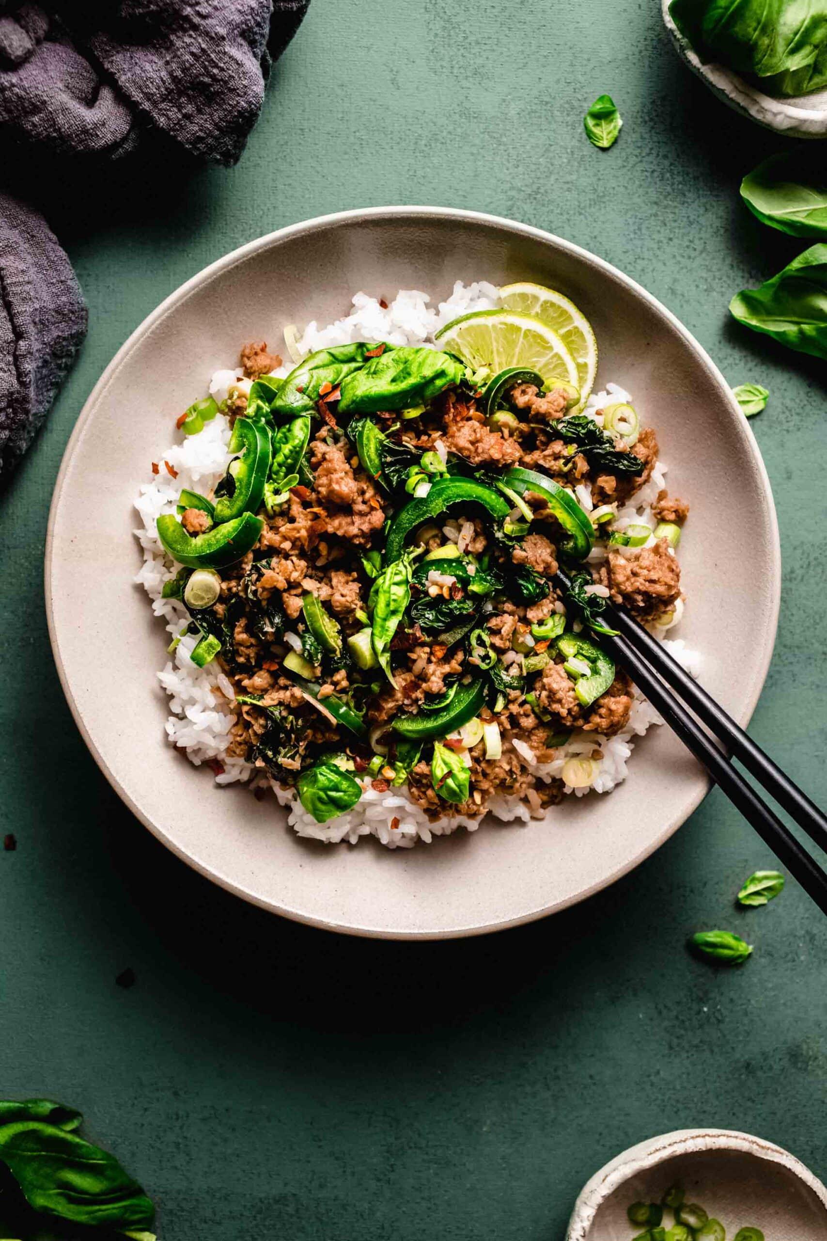 Close-up shot of sizzling beef with Thai basil in a wok