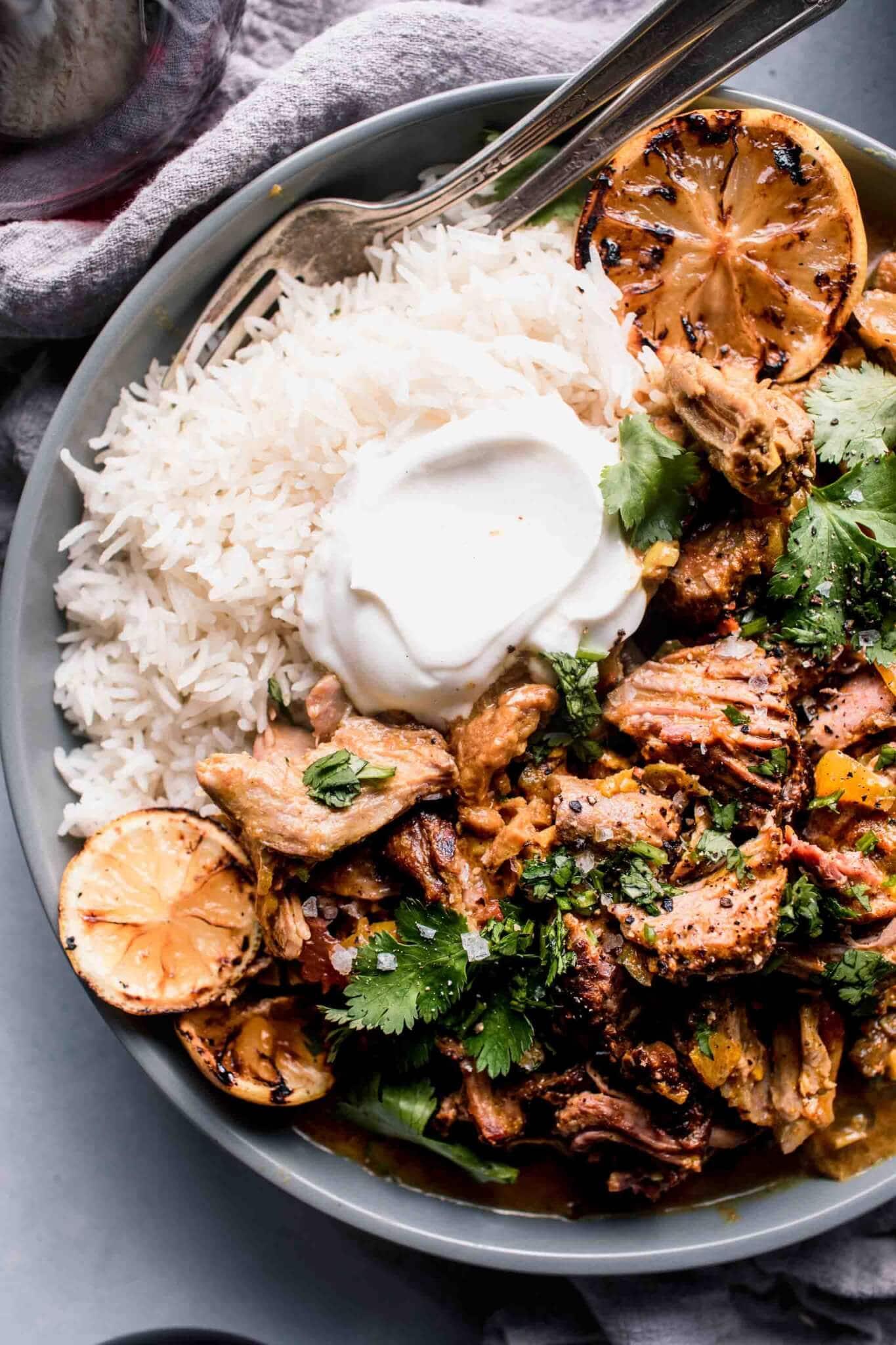 Overhead shot of lemon rosemary rice in a bowl, with lamb kebabs on the side