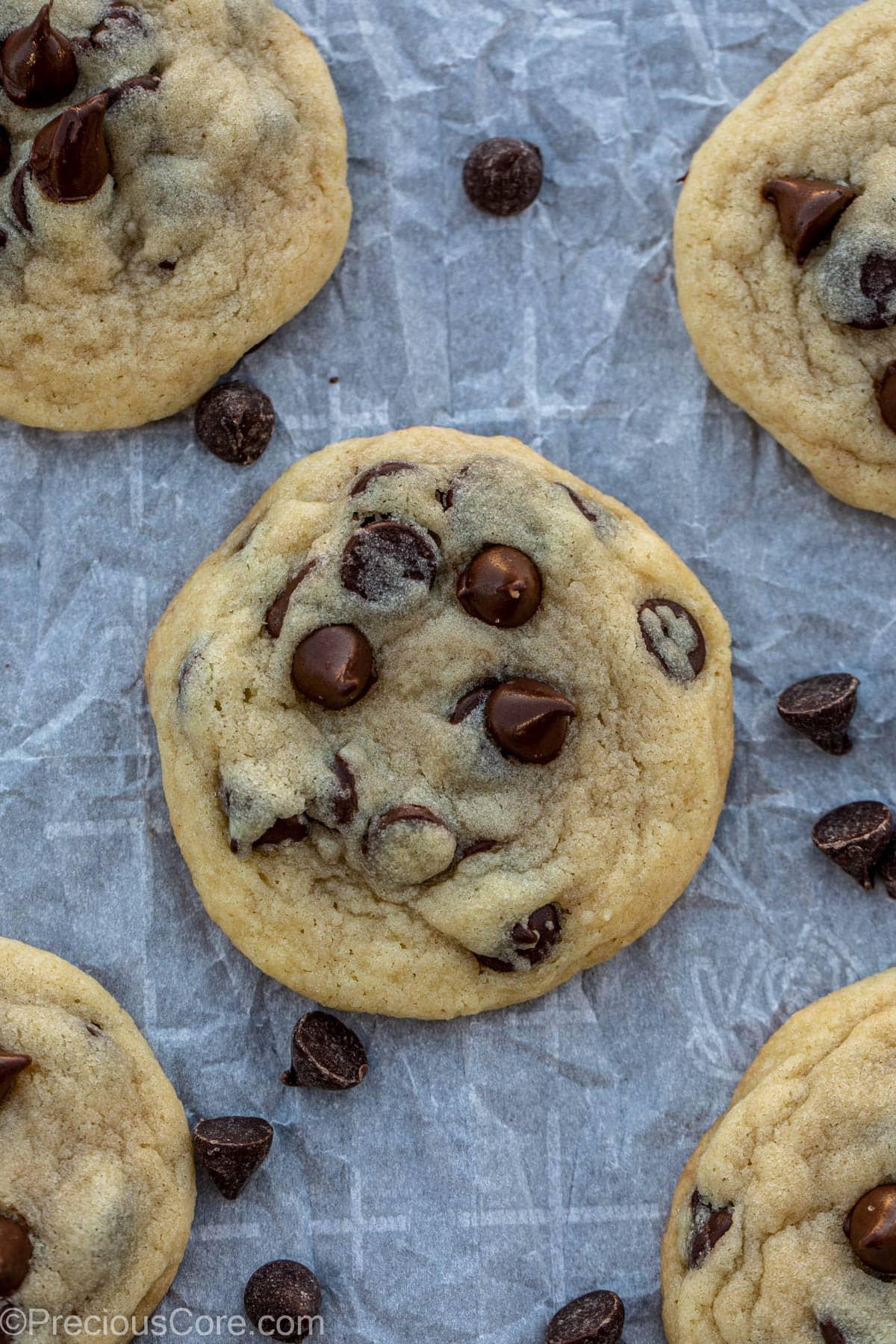Close up of cookie dough with chocolate chips being scooped onto parchment paper