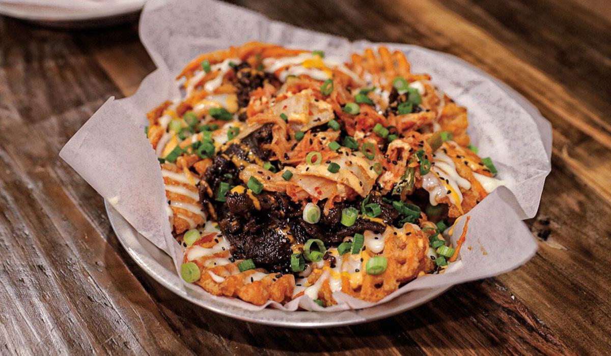 Close-up of a kimchi waffle taco being assembled