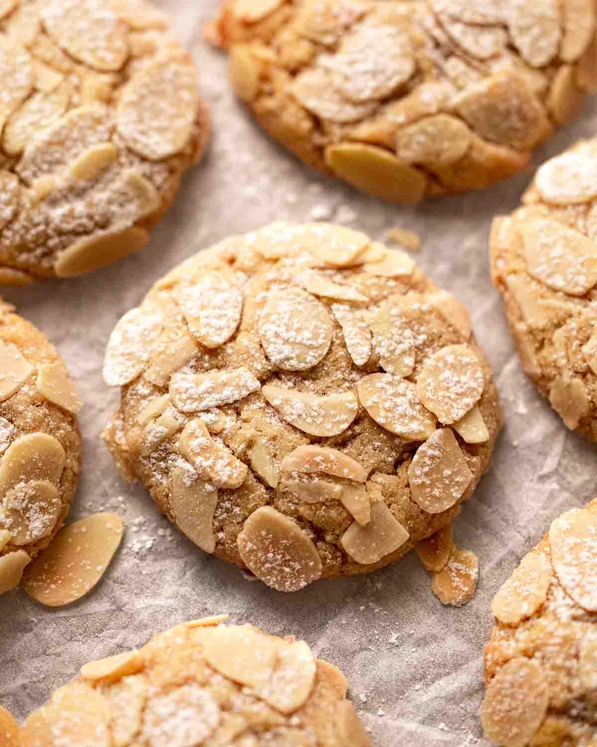 golden brown almond cookies with crisp edges, close up, warm light