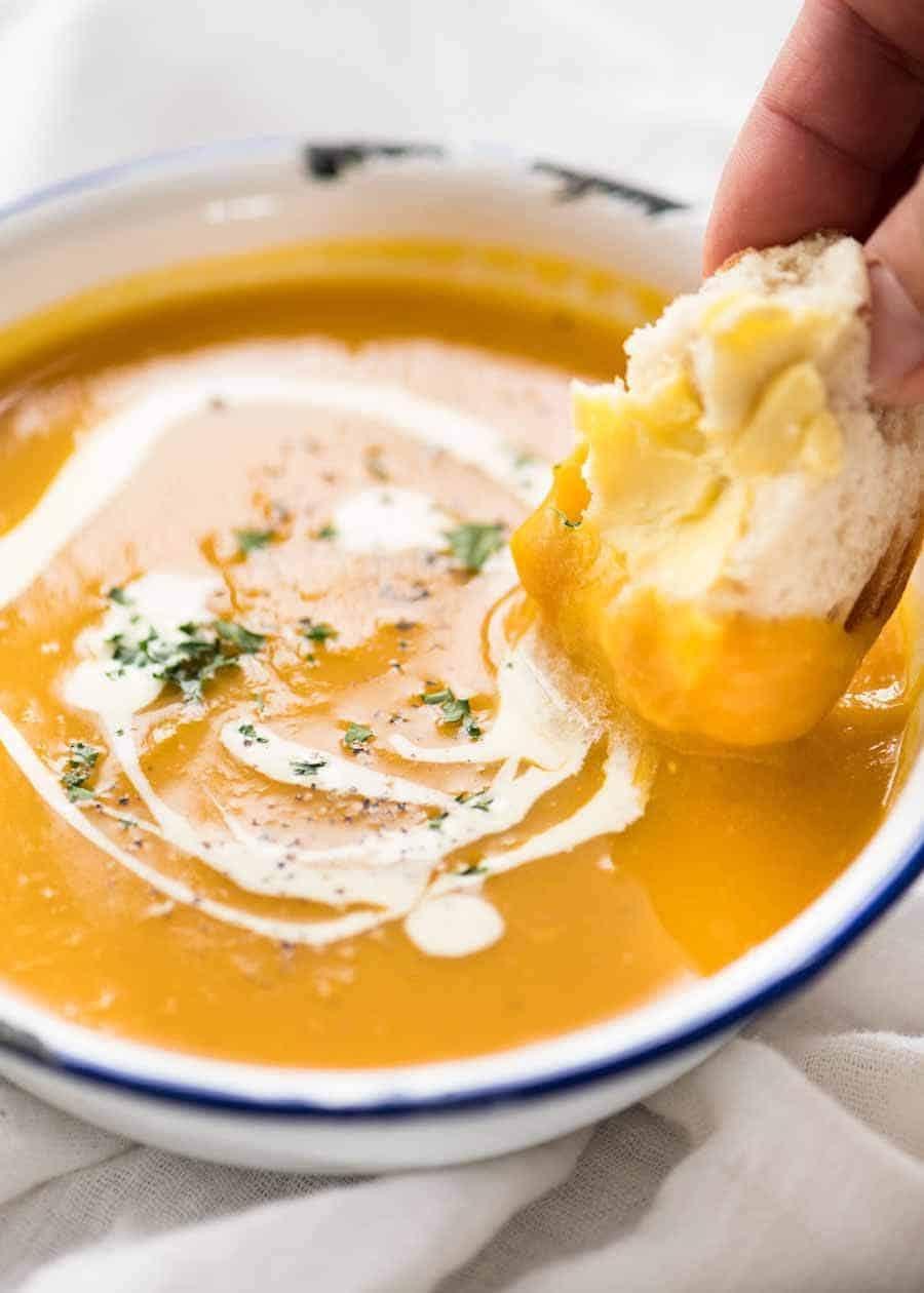 close-up of creamy roasted garlic pumpkin soup in a rustic bowl