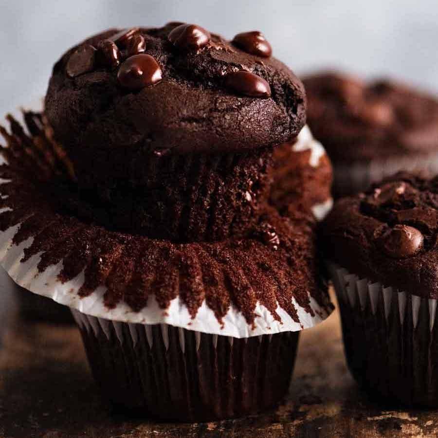 delicious chocolate cookie muffins with a gooey chocolate center, warm, rustic lighting, baked goods