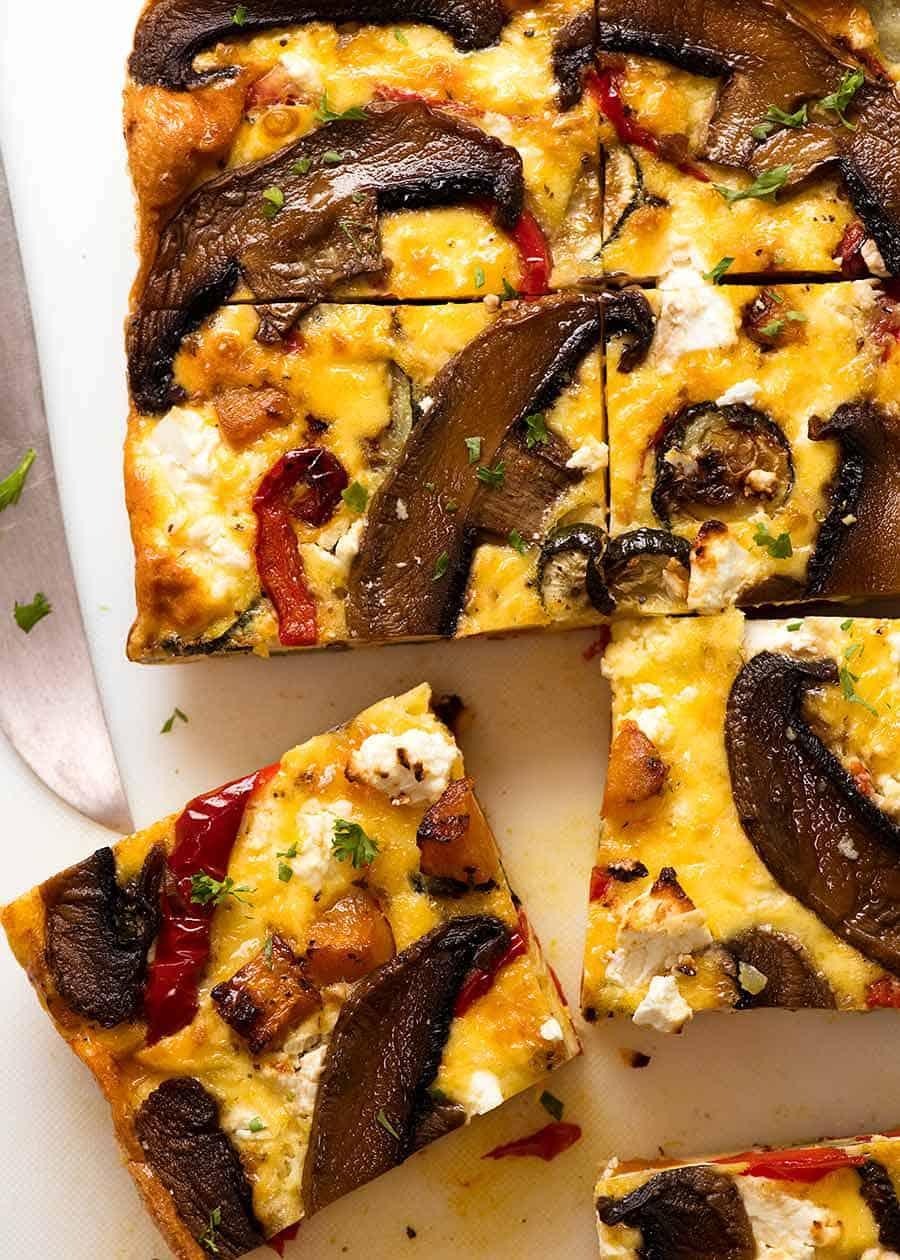 slicing a freshly baked frittata