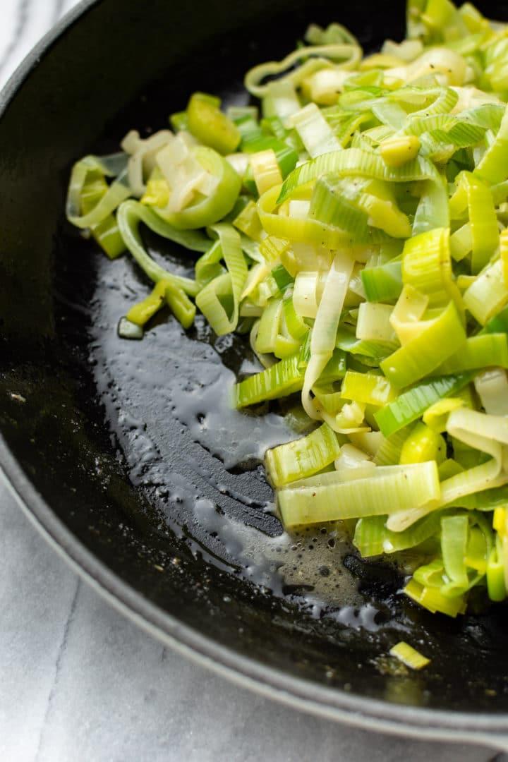 Close-up of leeks being sautéed in butter in a pot
