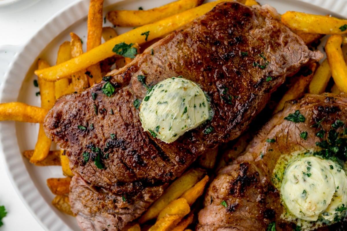 close up of steak frites french toast being drizzled with syrup