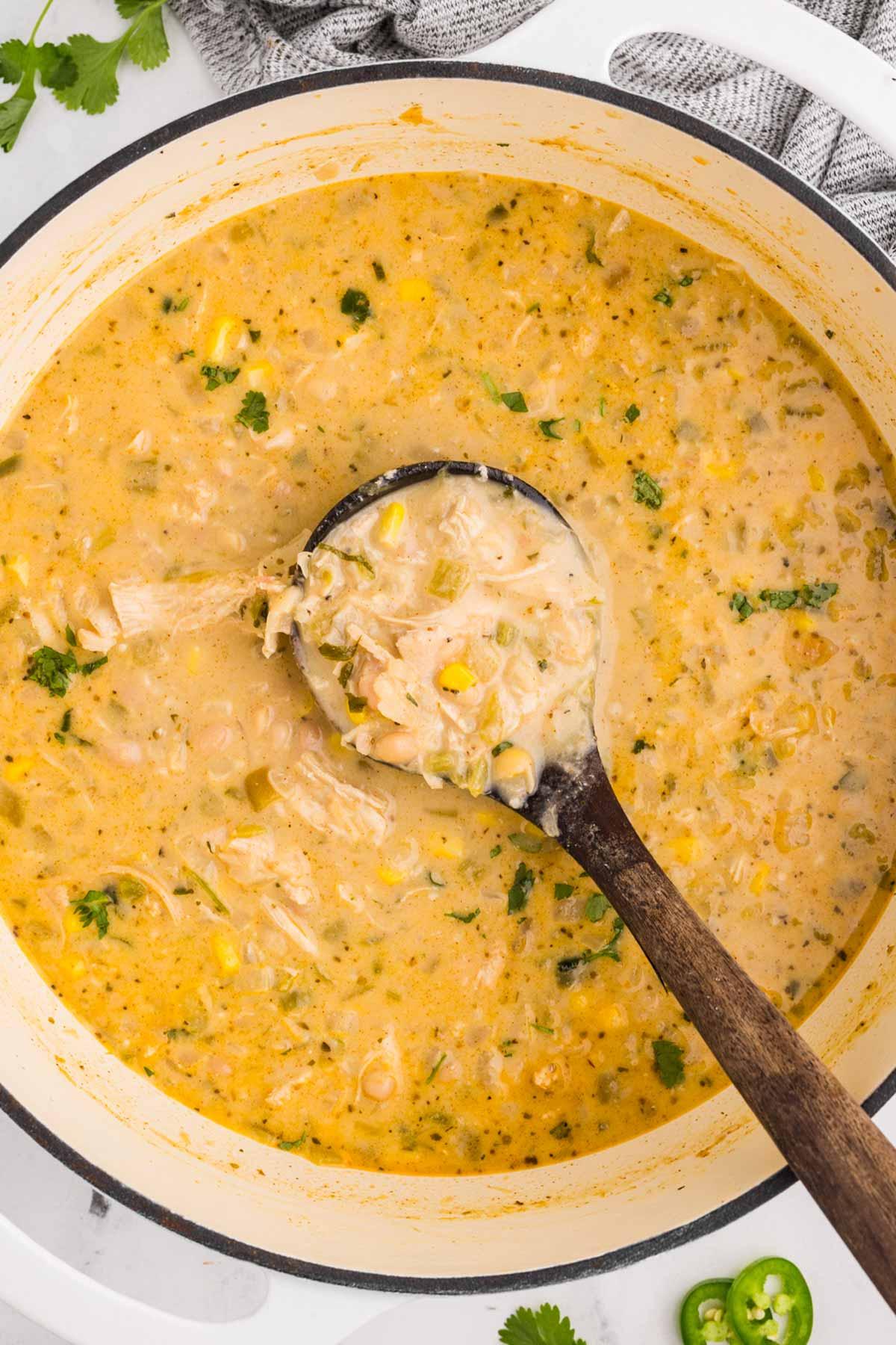 Overhead shot of a pot of white chicken chili simmering on a stovetop