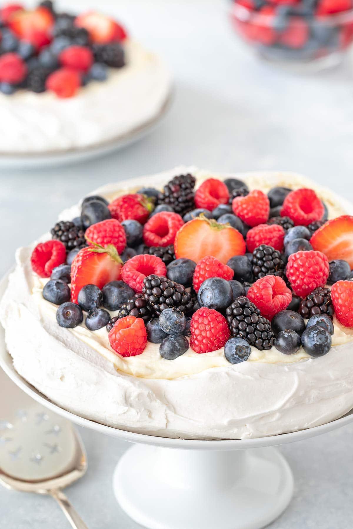 mixed berry pavlova on a rustic wooden table