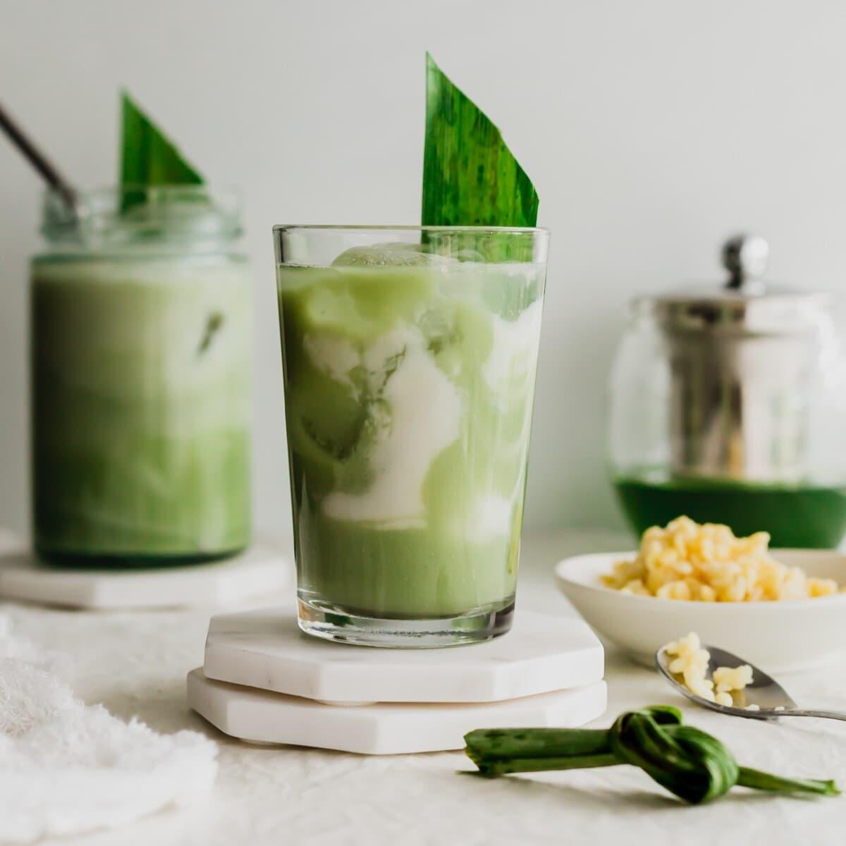 Pandan leaves being blended with coconut milk in a blender