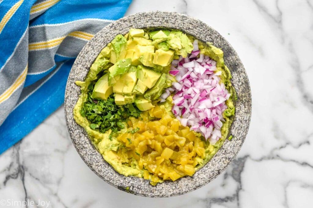 An overhead shot of a vibrant avocado wrap being assembled, showcasing the colorful ingredients.