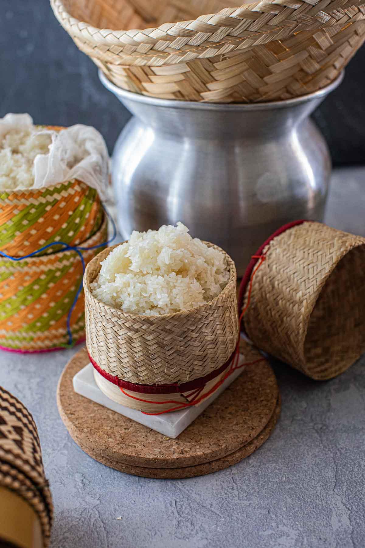 steaming rice with chives and parsley in a bamboo steamer
