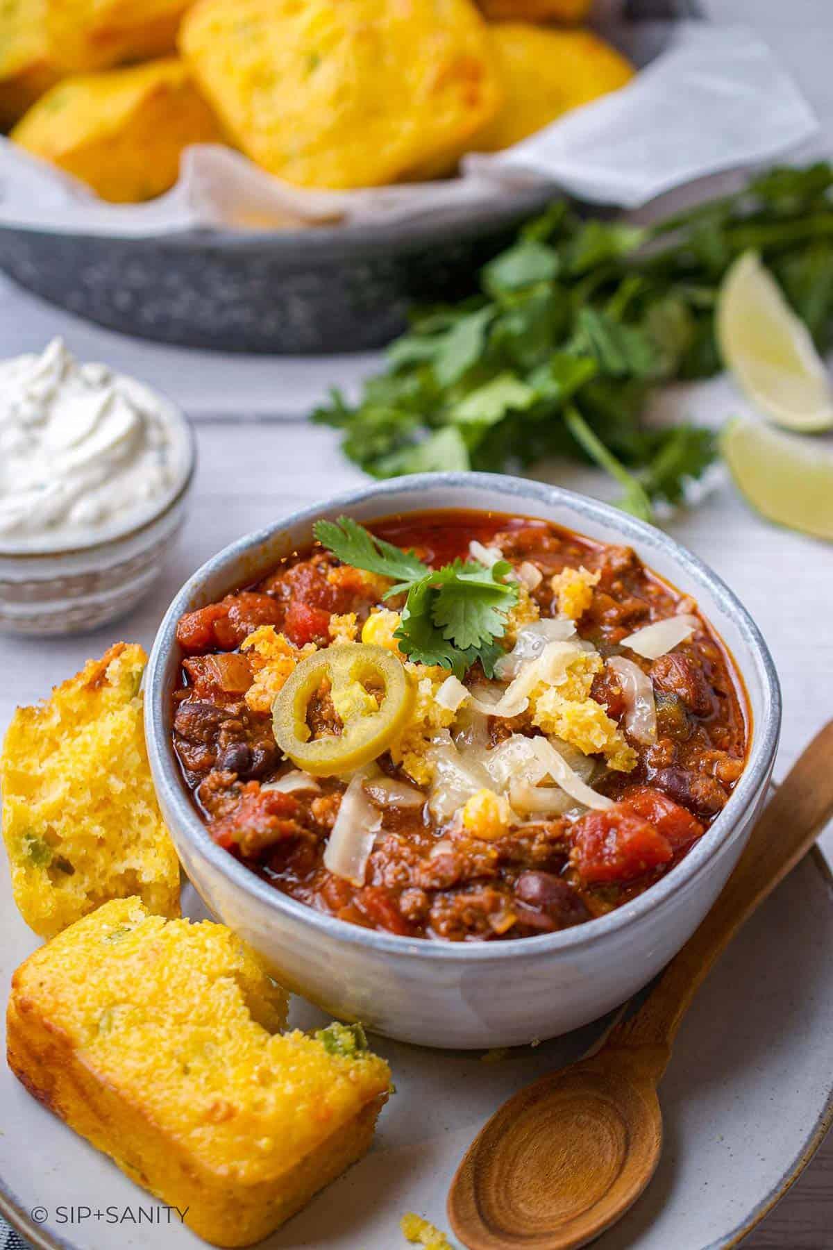 a bowl of slow-cooker chorizo corn chili with toppings, ready to be served