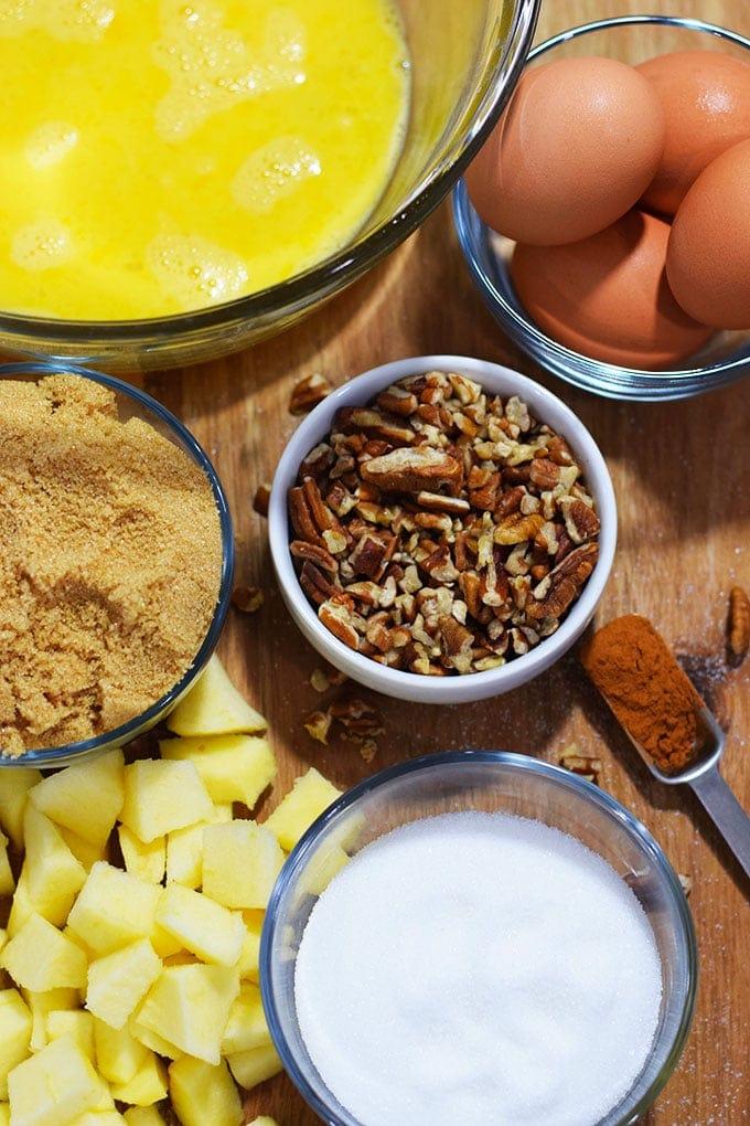 Ingredients for bourbon pecan bread pudding laid out on a wooden table.